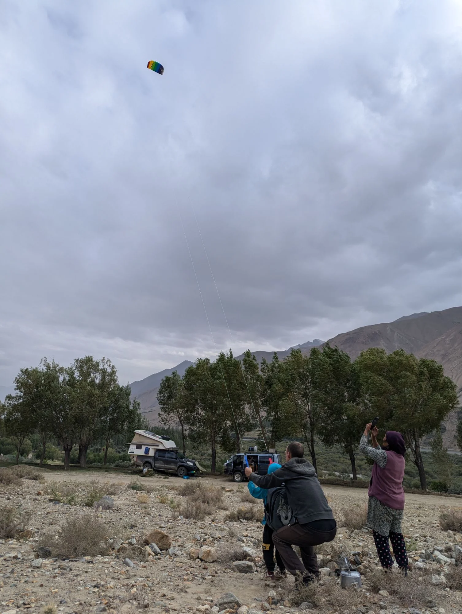 We went further south along the river separating Tajikistan from Afghanistan. It was interesting to be there and see Afghanistan and the Afghan people on the other side of the river. I guess mainly because of the news reports, I have a biased attitude towards Afghanistan and it was interesting to feel that. We had to pass several military checkpoints and one soldier tried to get money from Simon for having the horns Racki had gifted him. But all went good. At one camp spot we got moved by the soldiers patrolling the river. It was not so easy to find camp spots and I would recommend everyone to just skip the border area where you are not able to keep at least a kilometer of distance to the river. We had some windy days and took the opportunity to play around with our kite. The local children loved it as well and I thought about gifting the kite to them. But in the end I kept it.