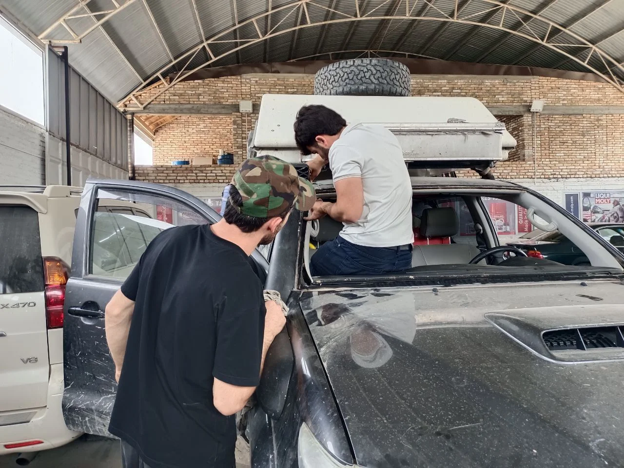 So we packed and went off to another place in the direction of Dushanbe because we could not think of another place nearby where we could get a new windshield. The next morning, we researched for a mechanic in Dushanbe on Google Maps and iOverlander. We found a promising one and started messaging on Whats App. He could speak German and English and so the communication was easy. We made an appointment for the next day. At our nice green camp spot in Dushanbe, we met nice and lovely family who gifted us food. Racki gave them some of her beautiful bracelets in return.  Unfortunately I got a heavy diarrhea in the evening. Most of the night I spent shitting and in the morning, I even had to puke. I didn&rsquo;t know what caused it, but I was pretty much fucked.  But we needed to go to the mechanic because we had only two visa days left in Tajikistan and we did not know if the repair would run smoothly. And what is more the area where we wanted to go in Uzbekistan looked pretty rural on the maps and so there was very little hope to find a new windshield over there. At the mechanic I was barely surviving. But Racki talked to the mechanics and managed everything. They were super nice and we felt very good about what they would do. We briefly searched for the reason of a squeaking noise we had in the front of Rosinante, but I felt to tired and weak to investigate it thoroughly. And so we left into the direction of Uzbekistan once the windshield got repaired.